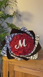 red inital bouquet with black & white dior wrapping